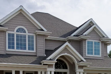 Large upscale house exterior with a columned entrance and stone accents