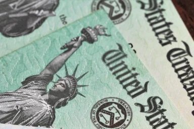 Close-up of a Social Security card next to a US Treasury check