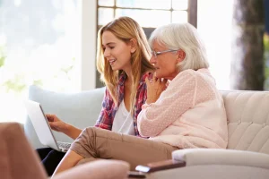 Younger woman and older woman looking together at a laptop screen