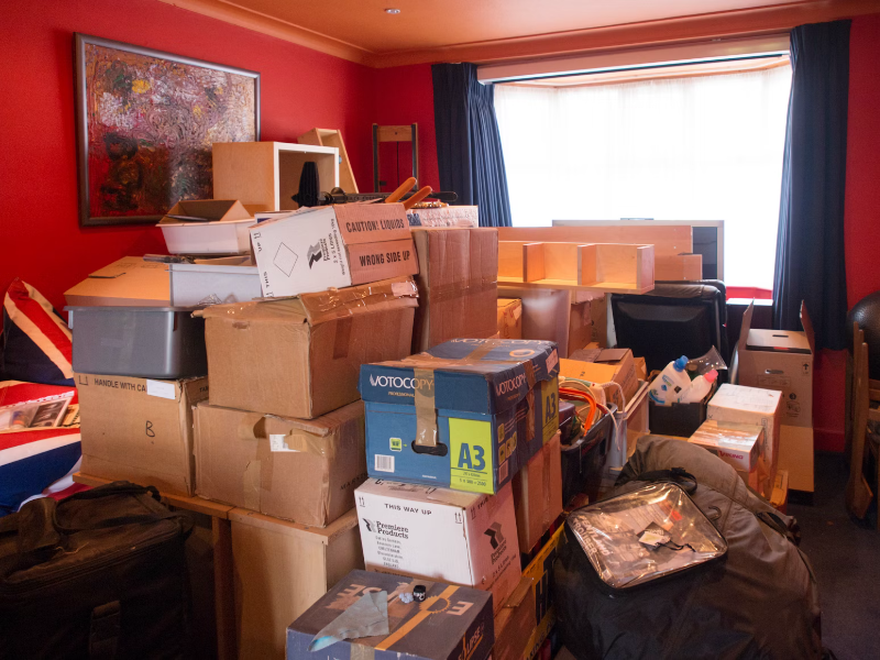 Cardboard boxes stacked in a living room