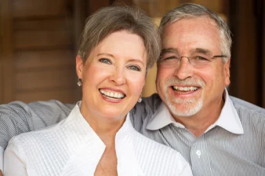 Smiling couple sitting together at home