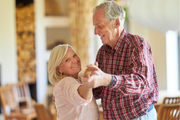 Couple dancing together at home