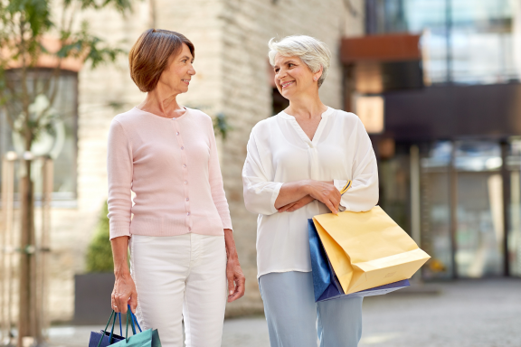 Two women walking together with shopping bags